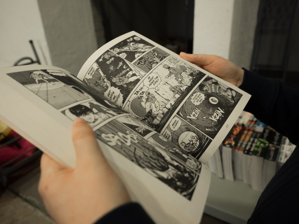 a close up of a man reading manga