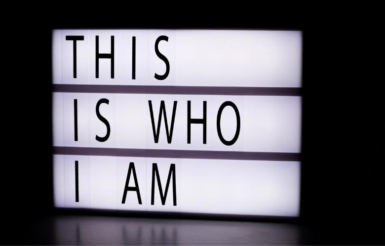 a lighted signage that says, this is who i am.