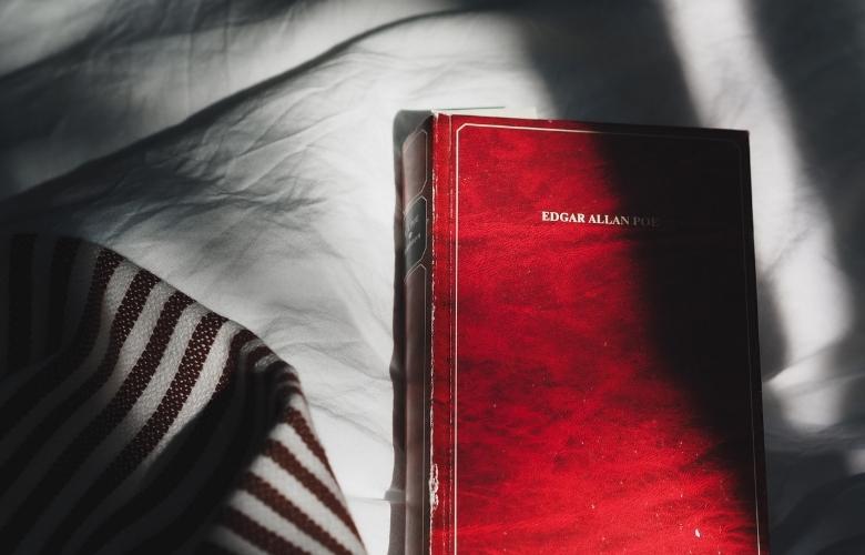 a red book with edgar allan poe's name on the cover