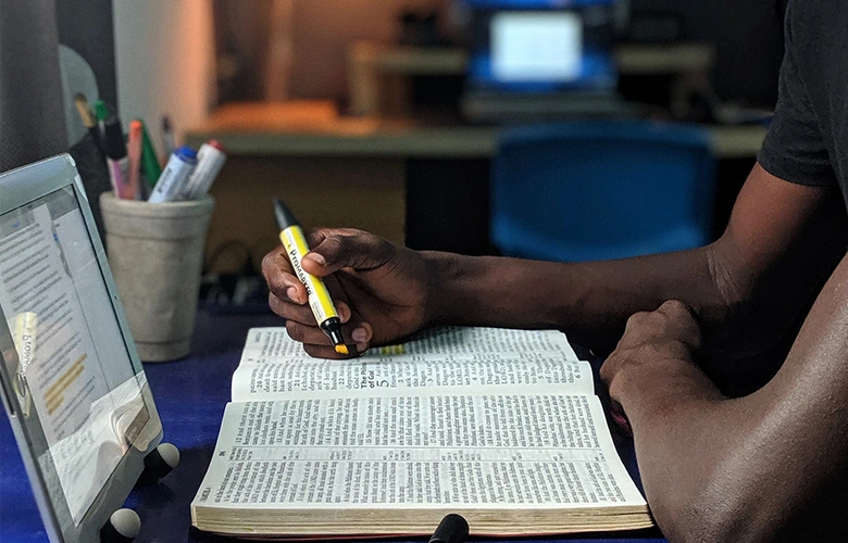 highlighting important information for his upcoming exam.